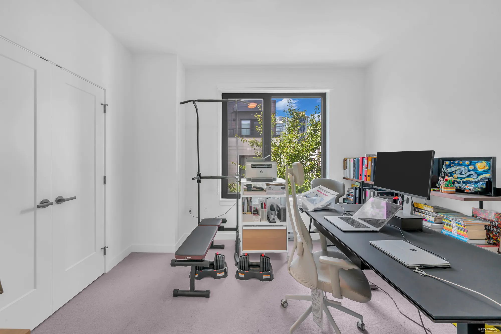 The same bedroom from its door: the double closet at the left, the window, the desk along the wall